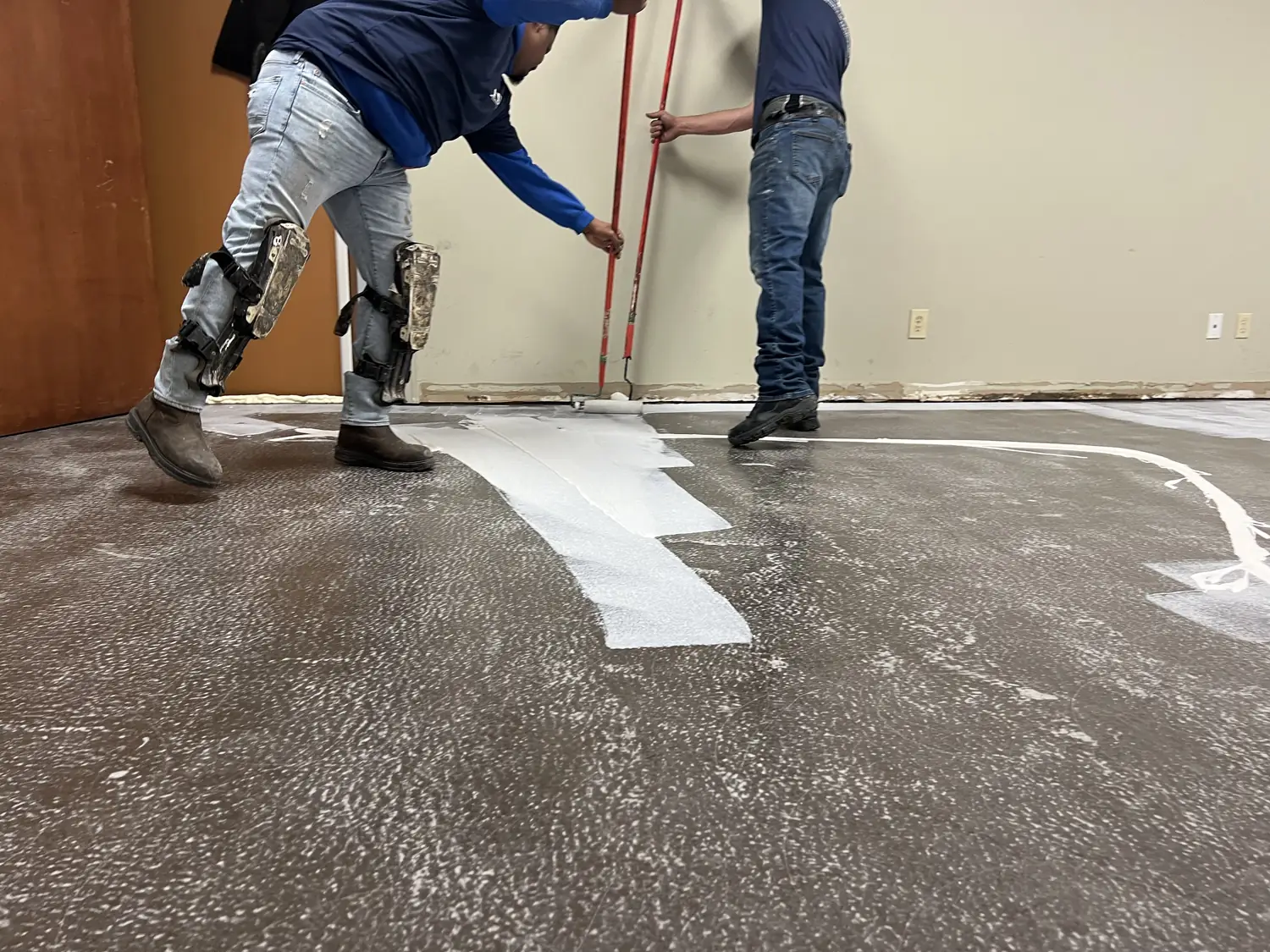 Low angle view of the boundary between abraded epoxy and freshly rolled white primer